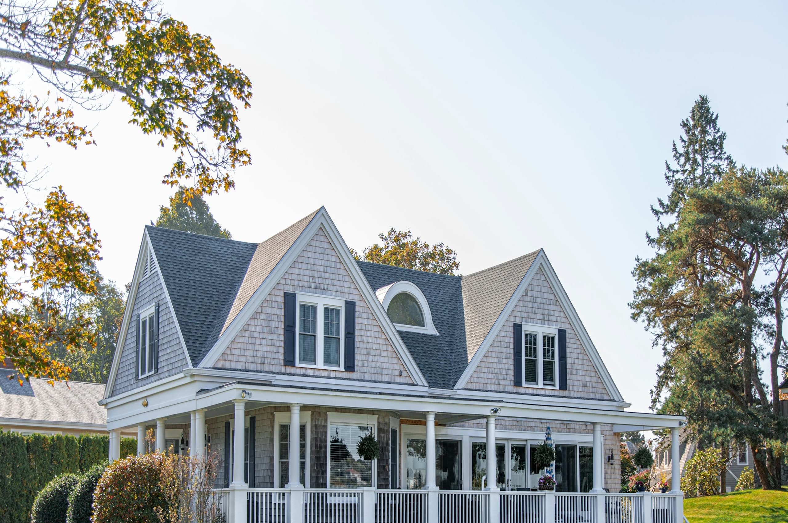 Dark architectural shingle roof on a premium Cape Cod style American home
